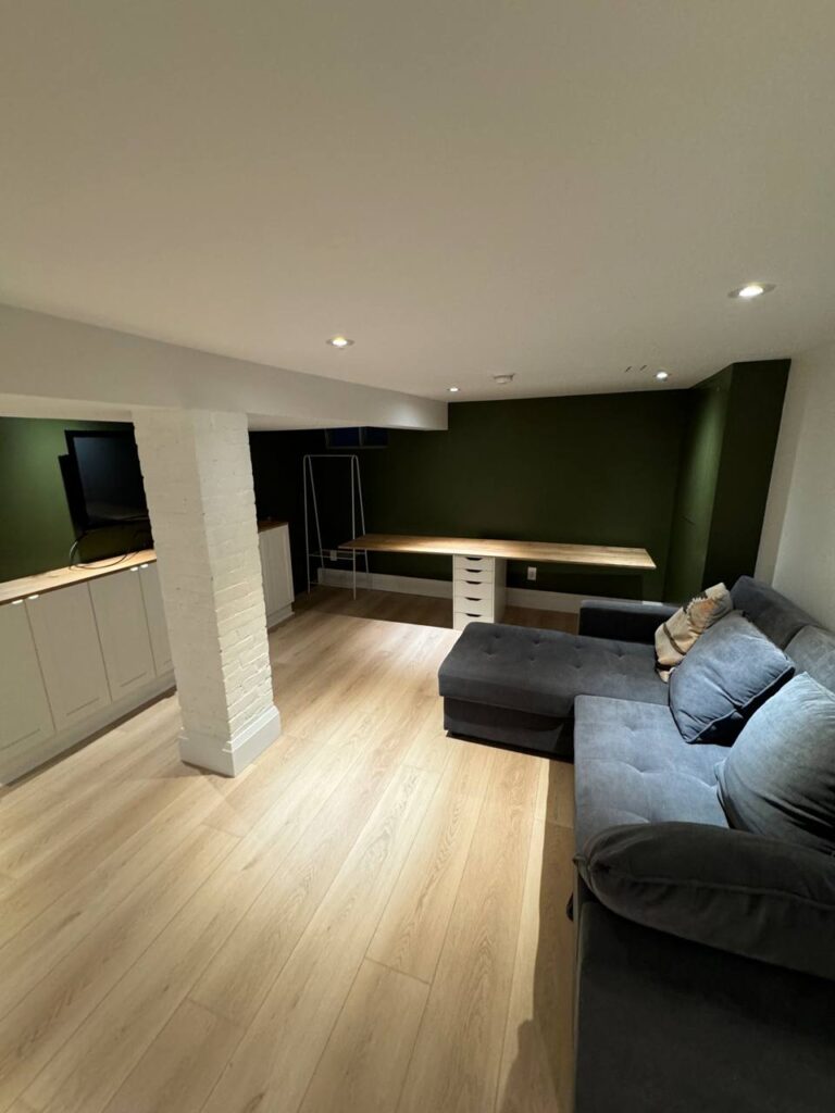 Cozy renovated basement lounge with open layout.