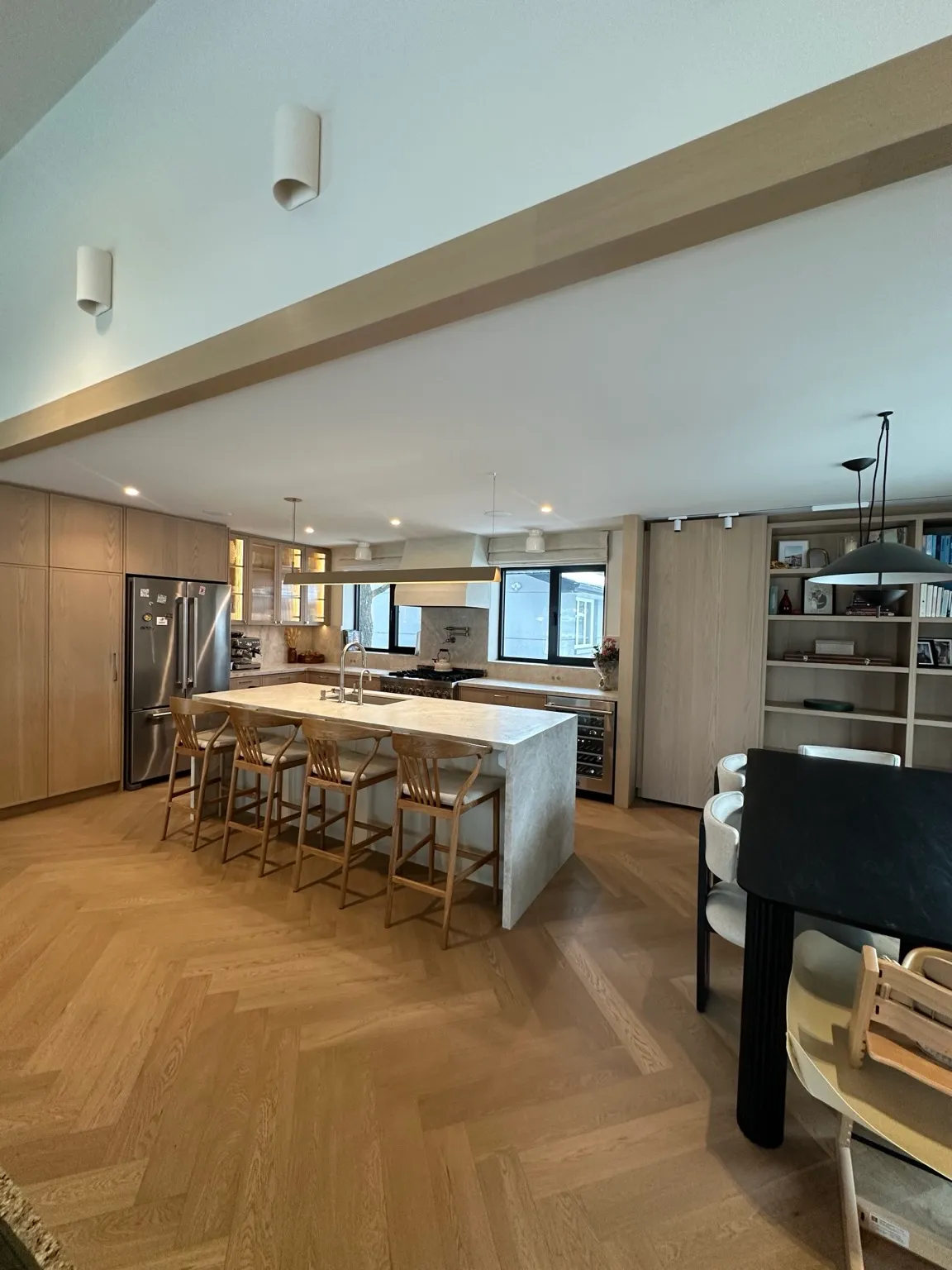 Etobicoke designer full home renovation with herringbone hardwood, custom staircase, trimless doors, white oak kitchen, and luxury bathrooms.