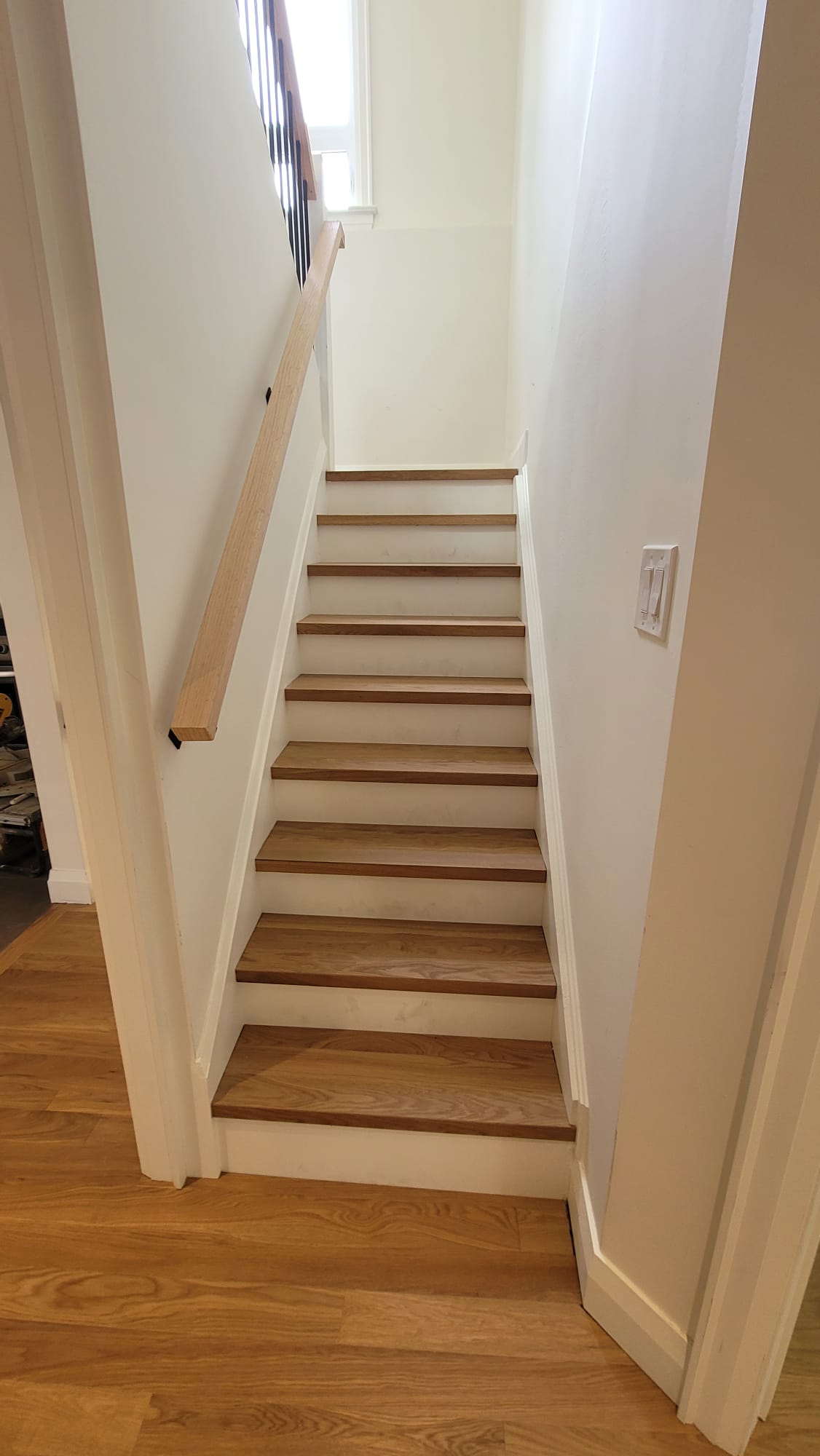 Hardwood floor staircase entryway