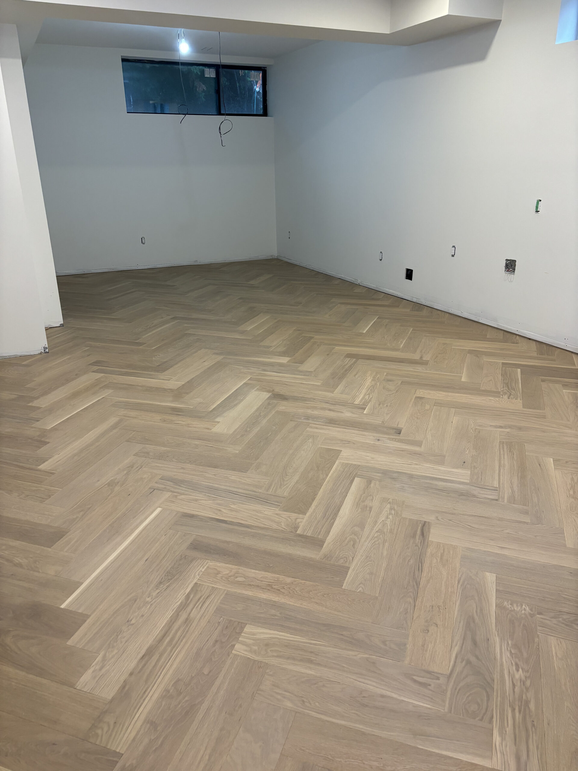 Basement room herringbone flooring installed