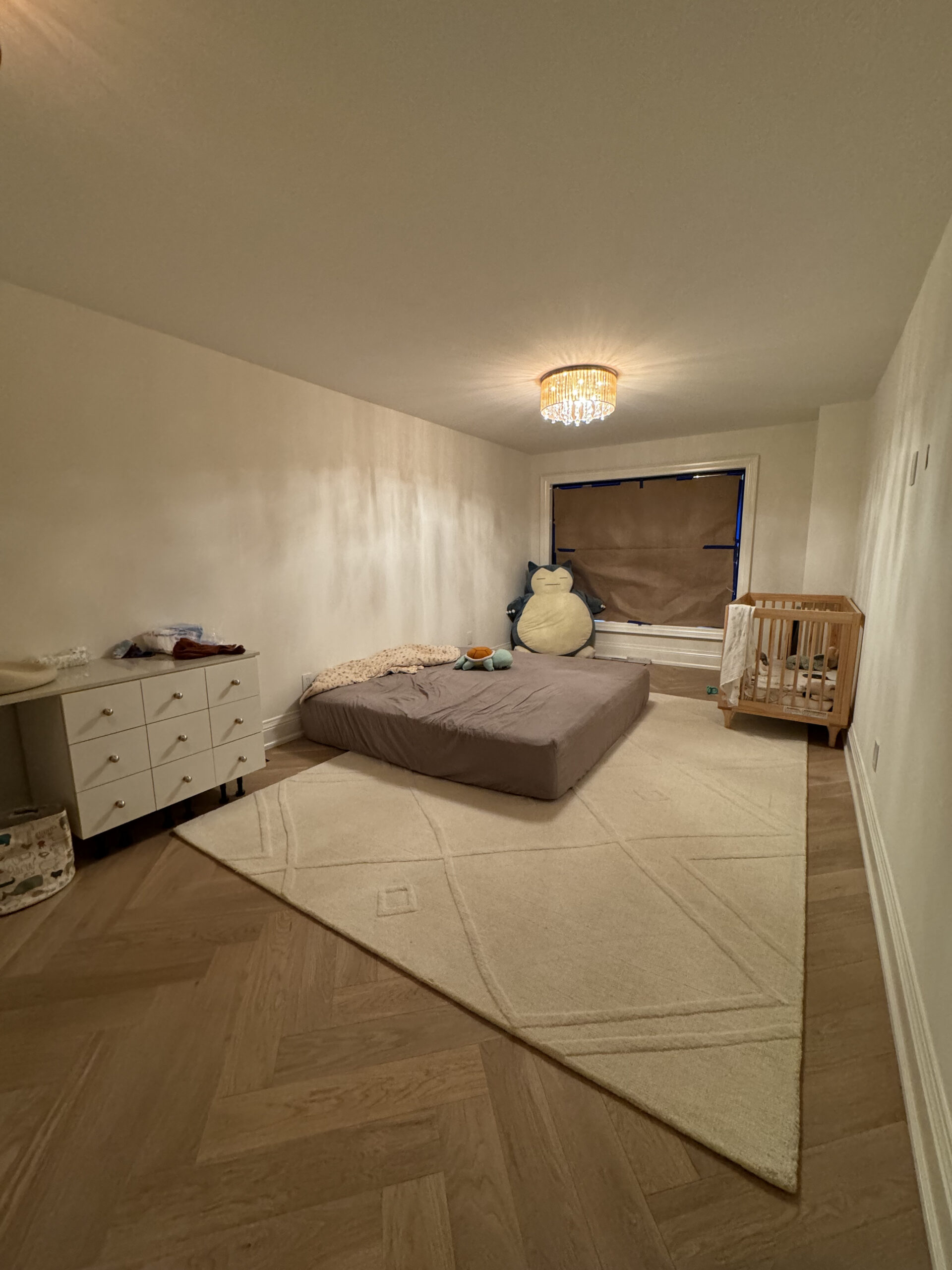 Cozy bedroom with modern lighting and herringbone floor