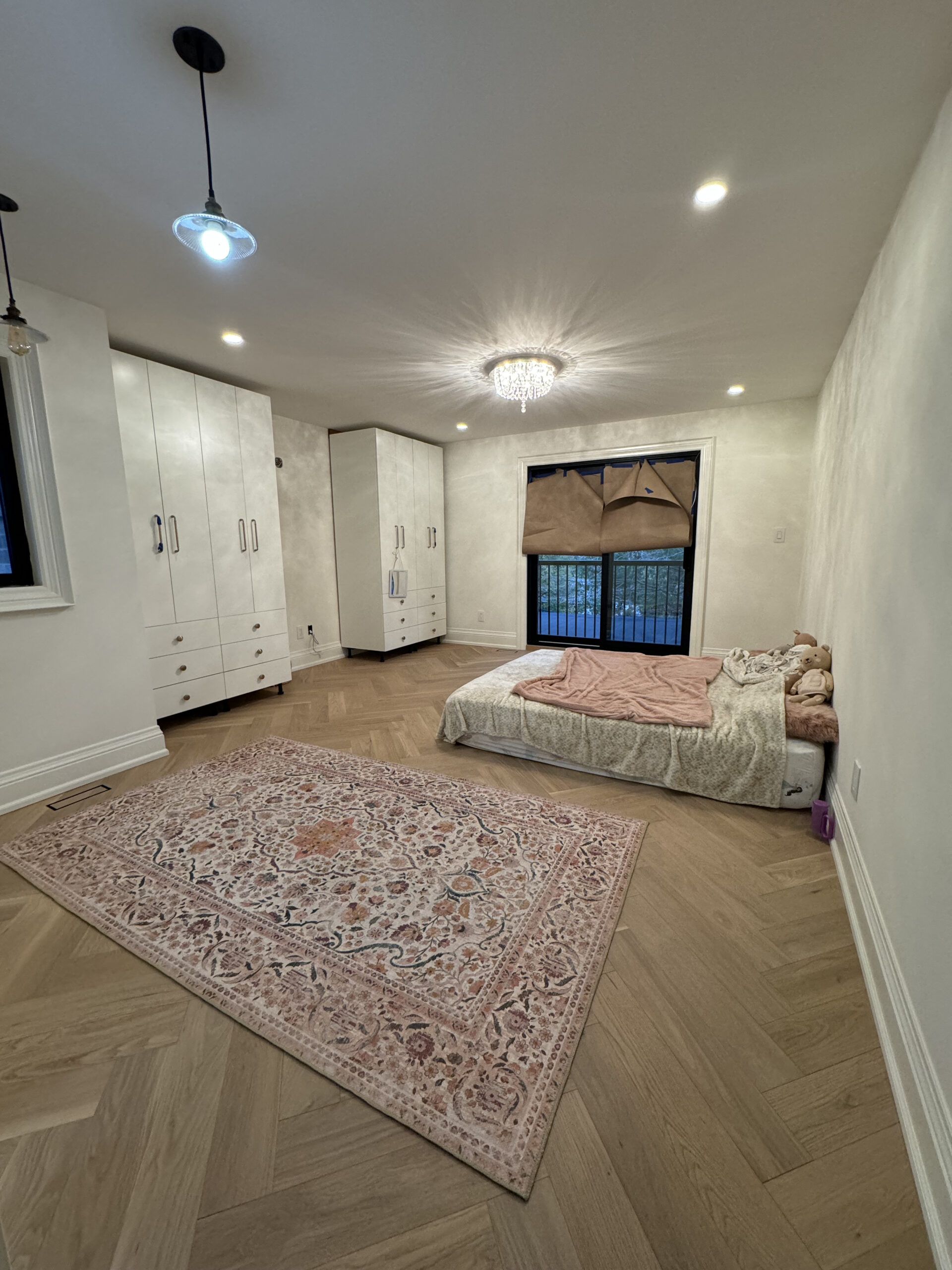 Kids bedroom herringbone floors and crystal chandelier