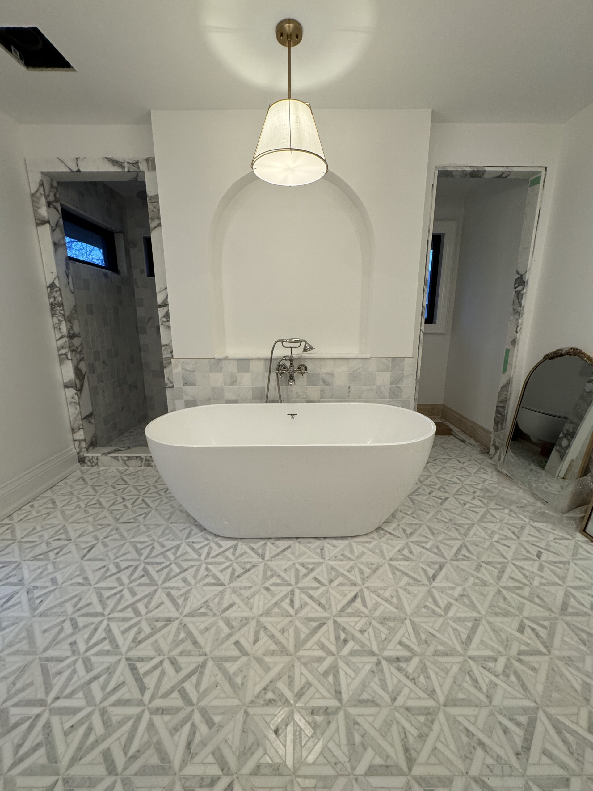 Modern bathroom with marble tile and freestanding tub