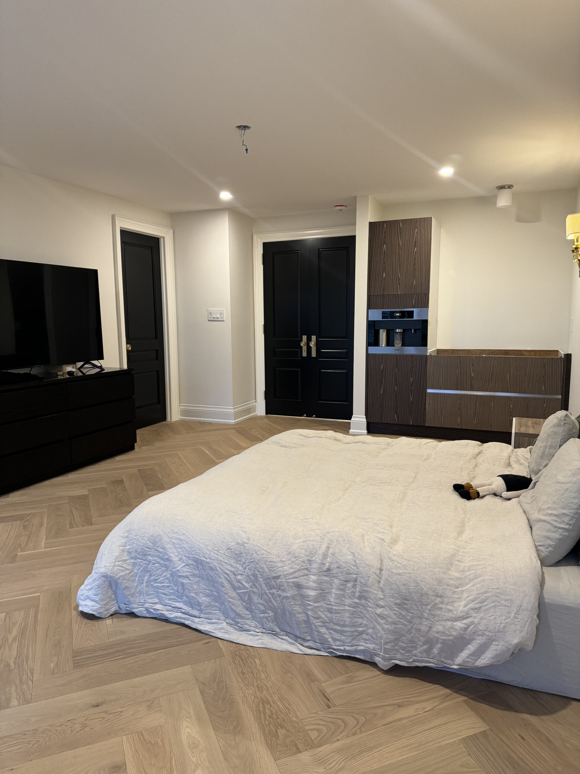 Modern bedroom black doors and built in cabinetry