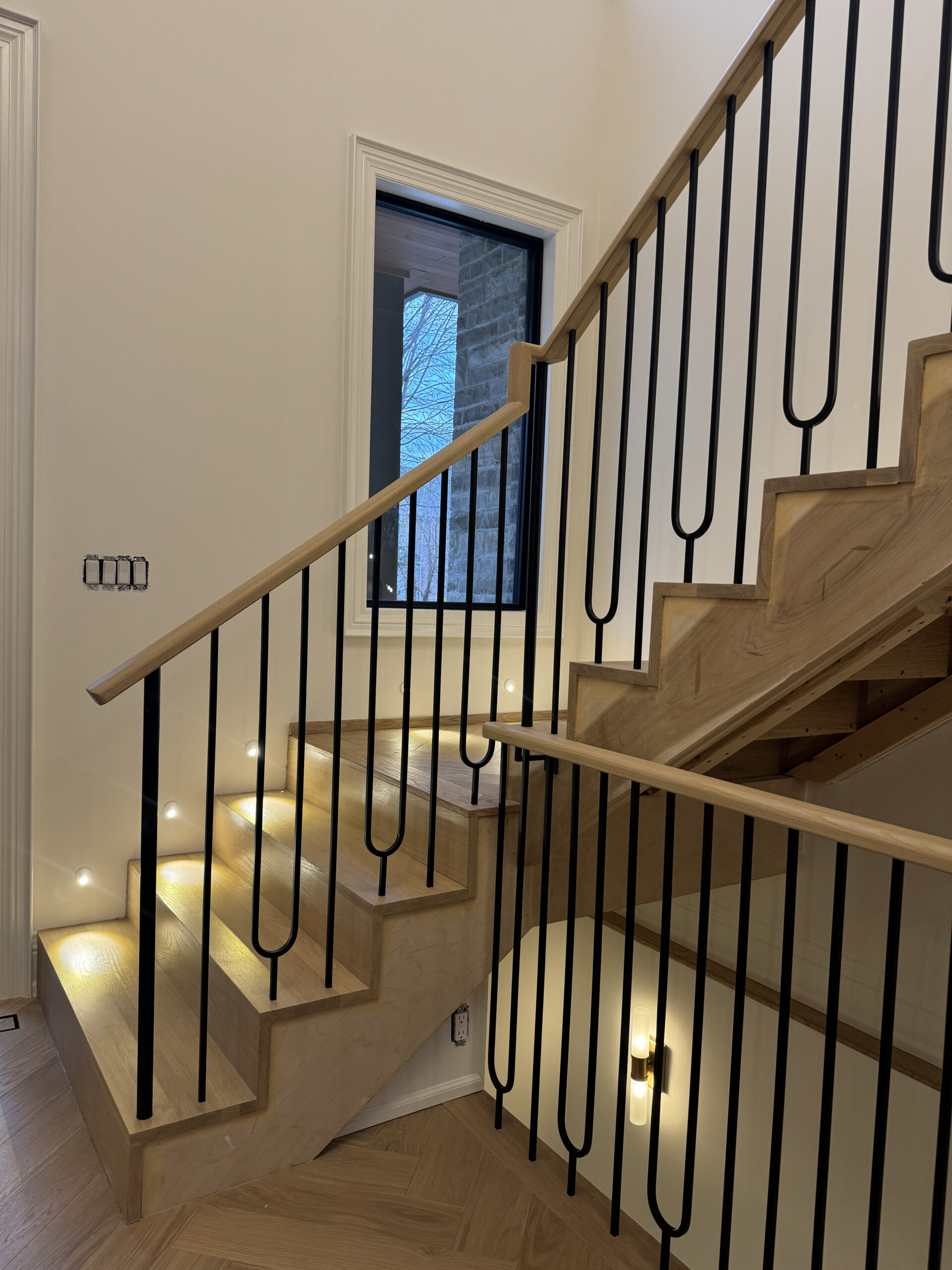 Modern staircase black spindles and led lighting