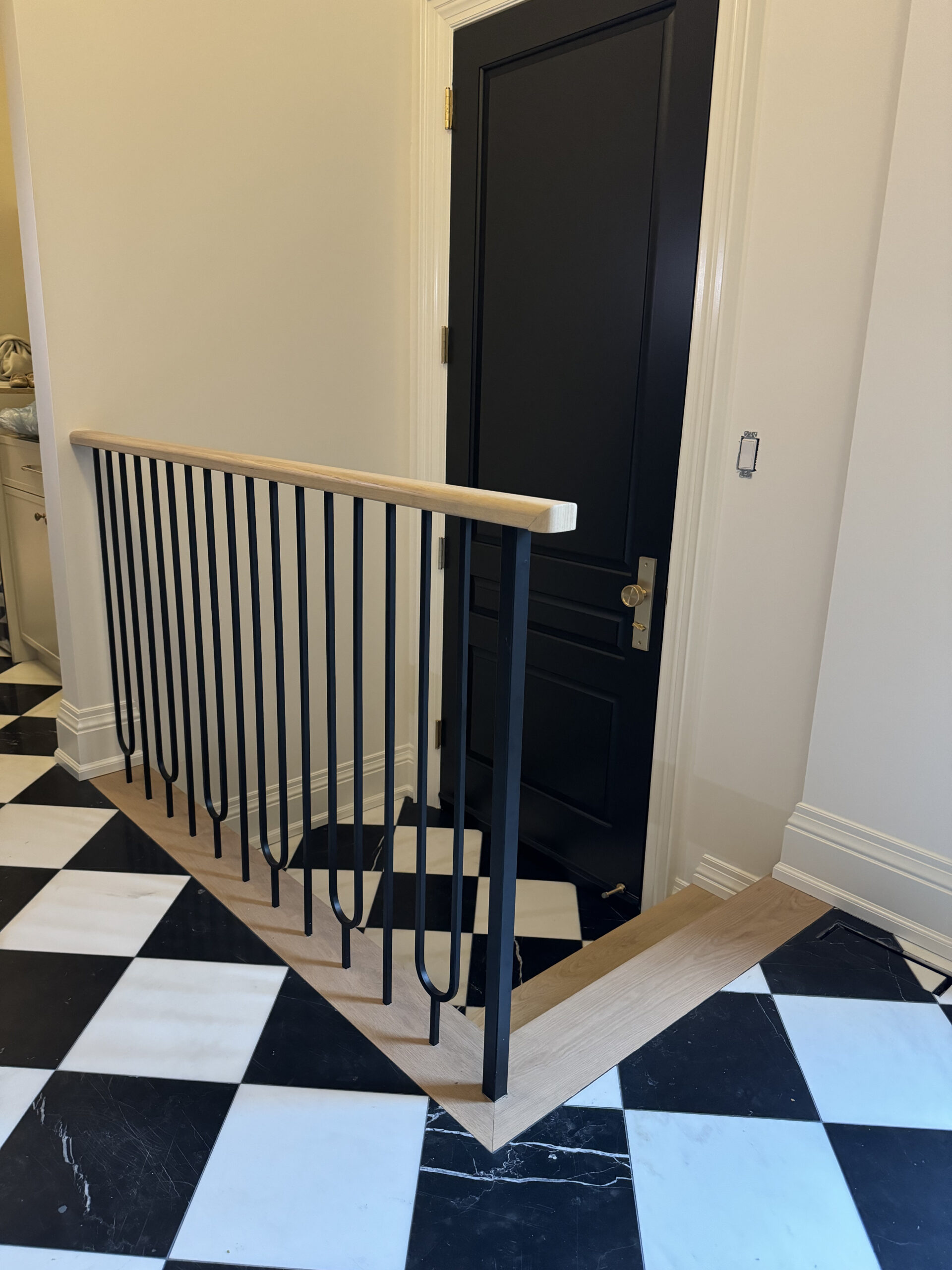 Modern staircase black spindles natural handrail