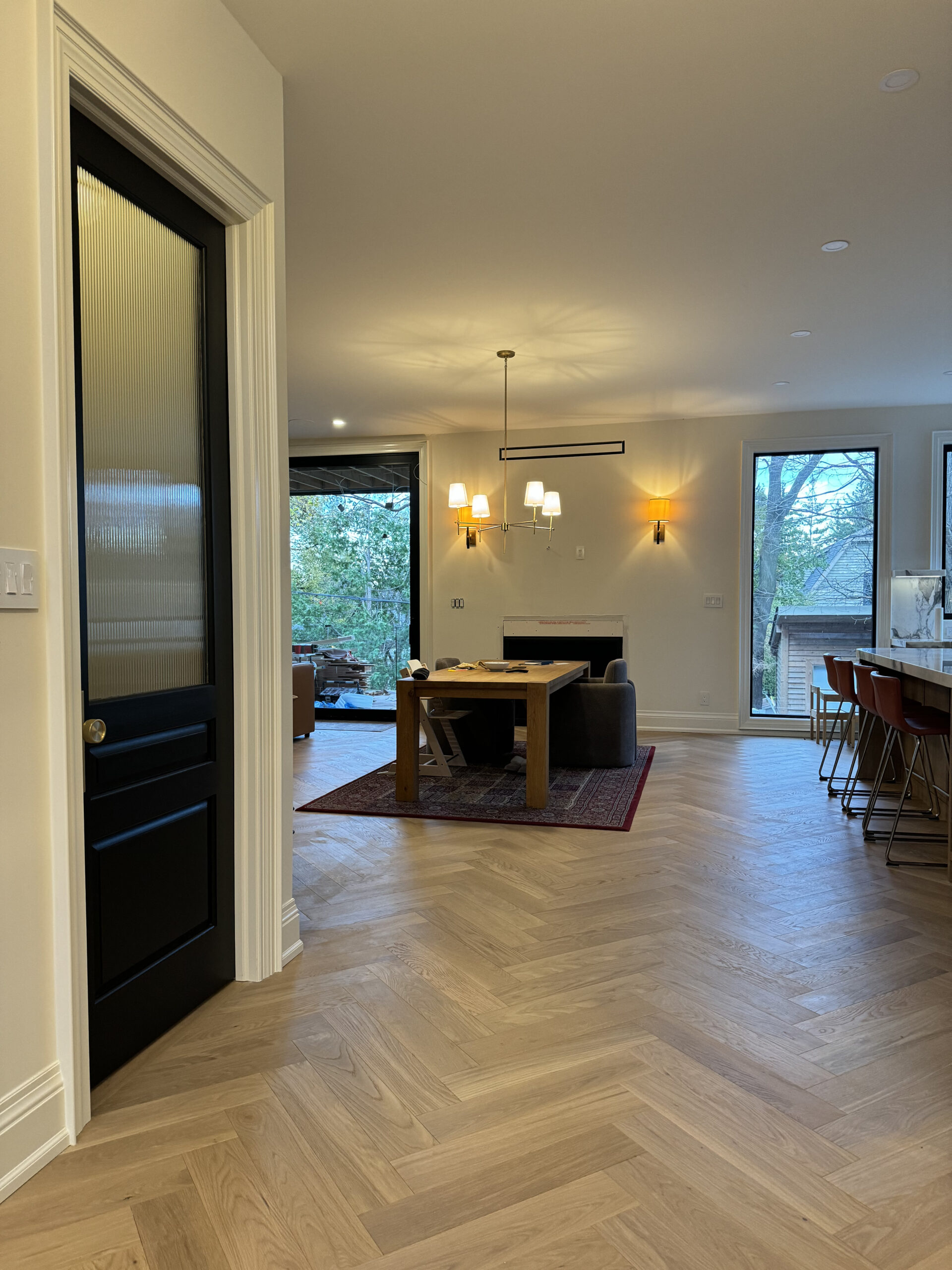 Open concept living and dining herringbone floors