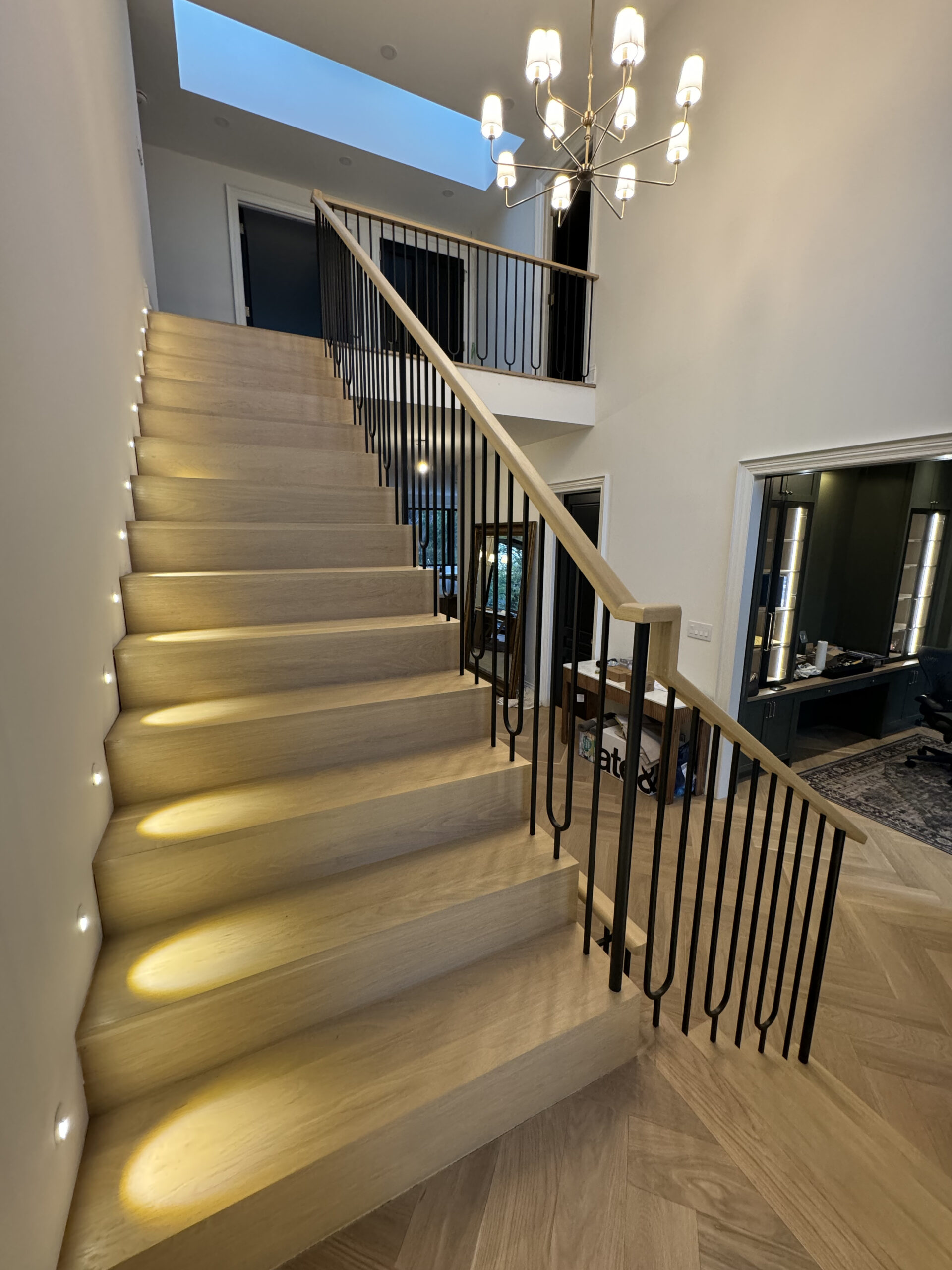Open staircase with natural wood and black railings