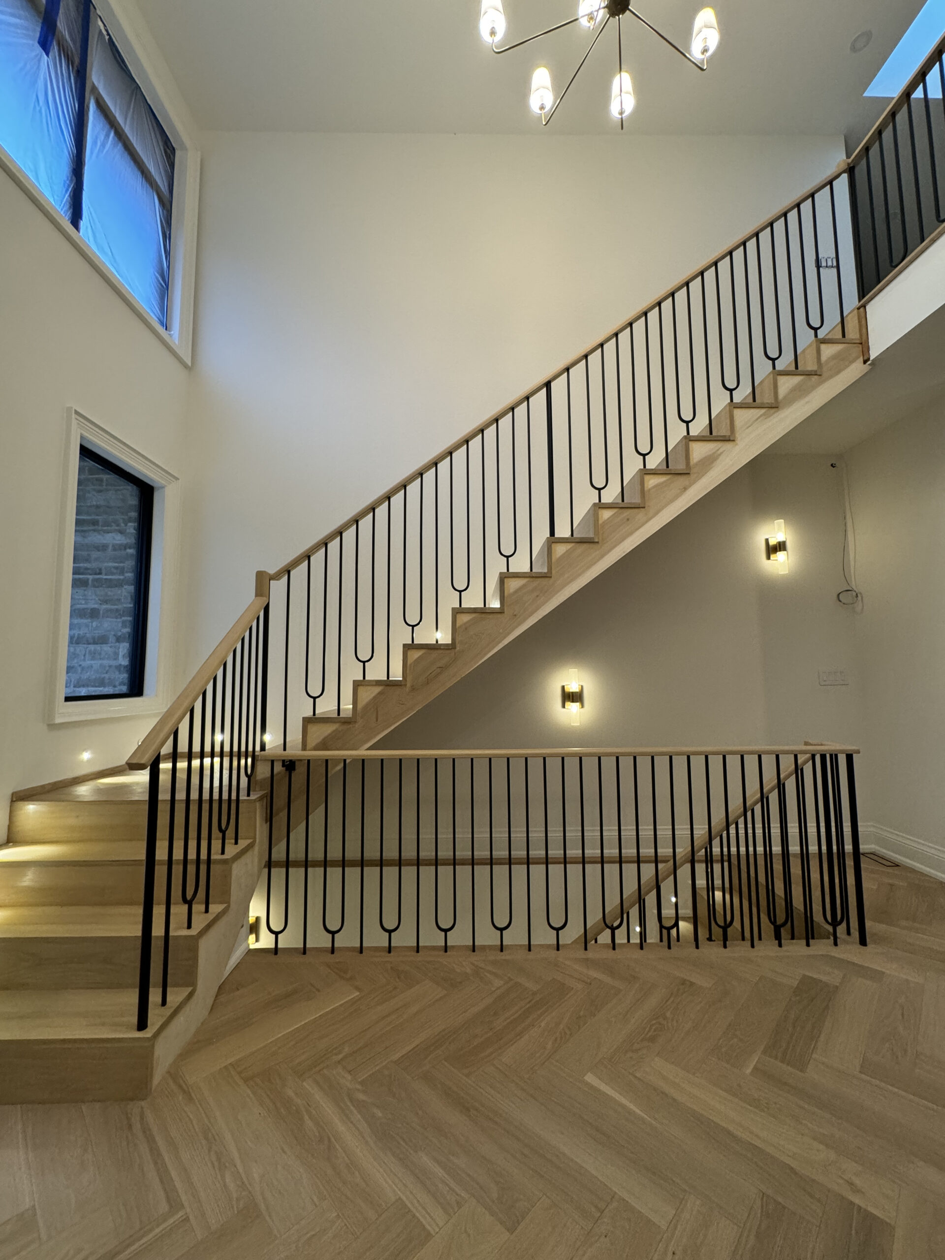 Staircase with modern lighting and natural finishes