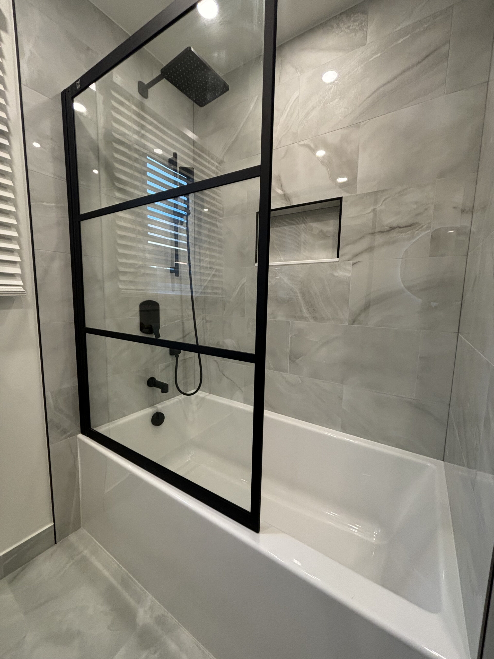 Oakville bathroom renovation tub shower black frame panel
