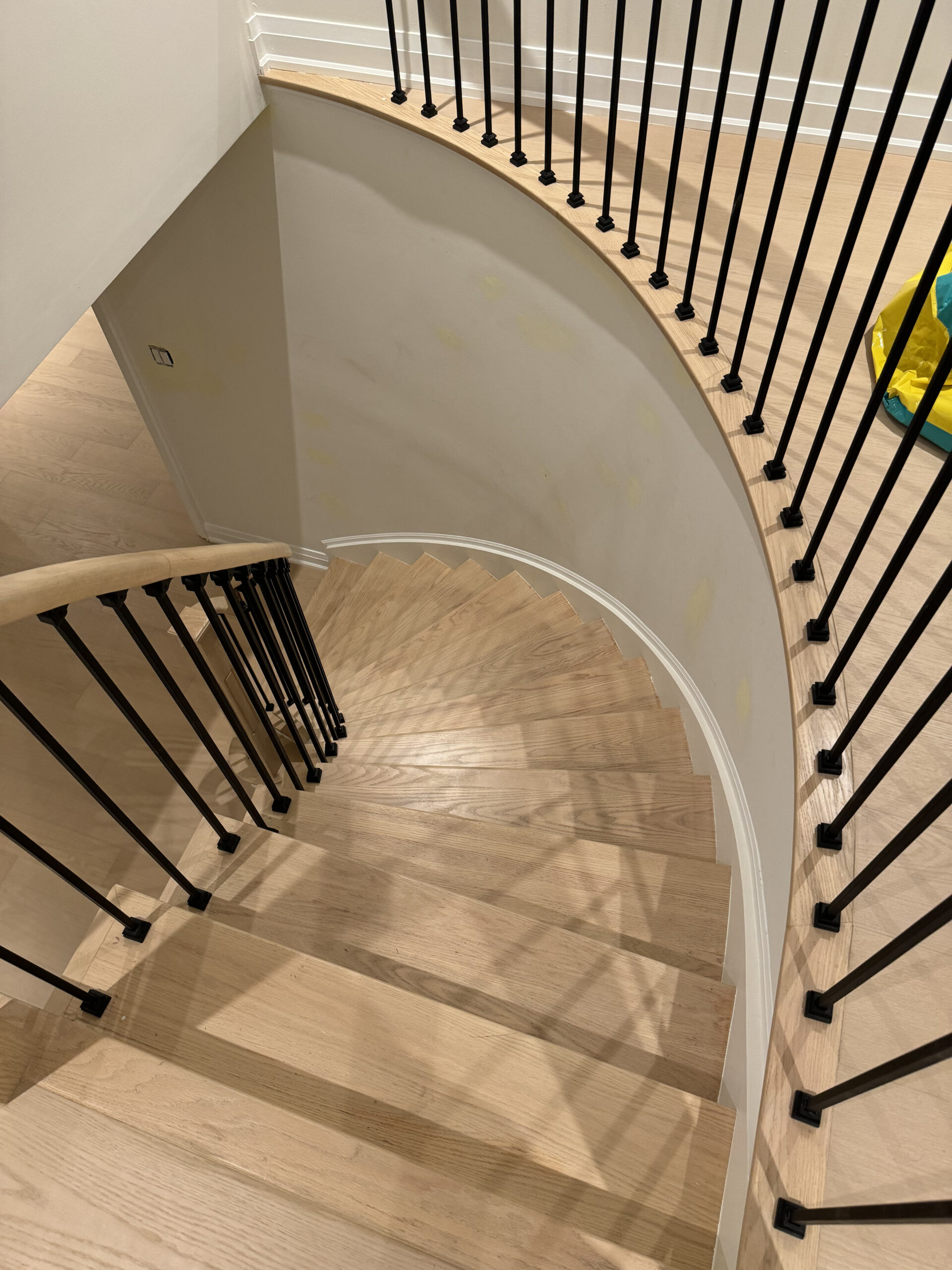 Curved staircase wrought iron detail oakville home