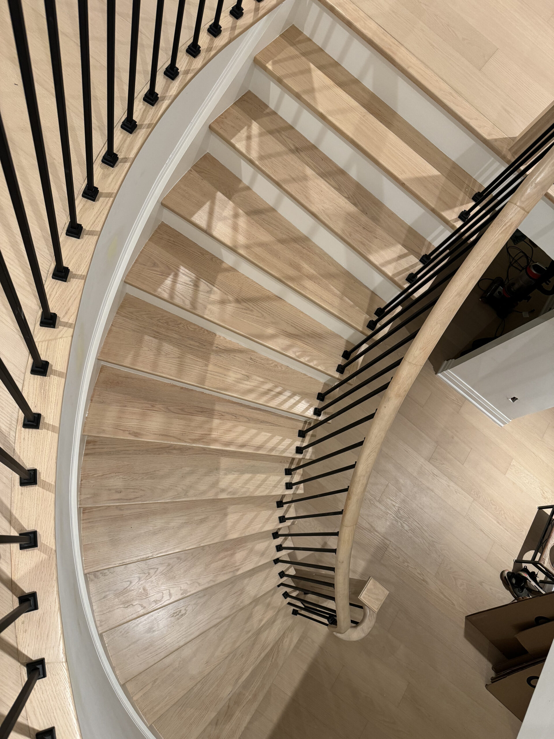 Remodeled staircase curved wooden railing