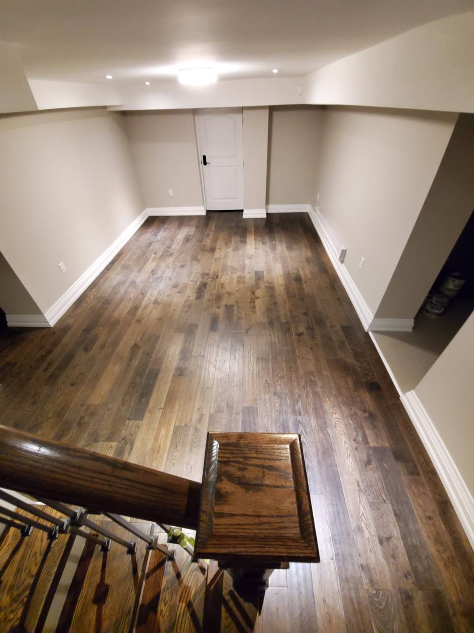 Basement apartment renovation hardwood flooring door view