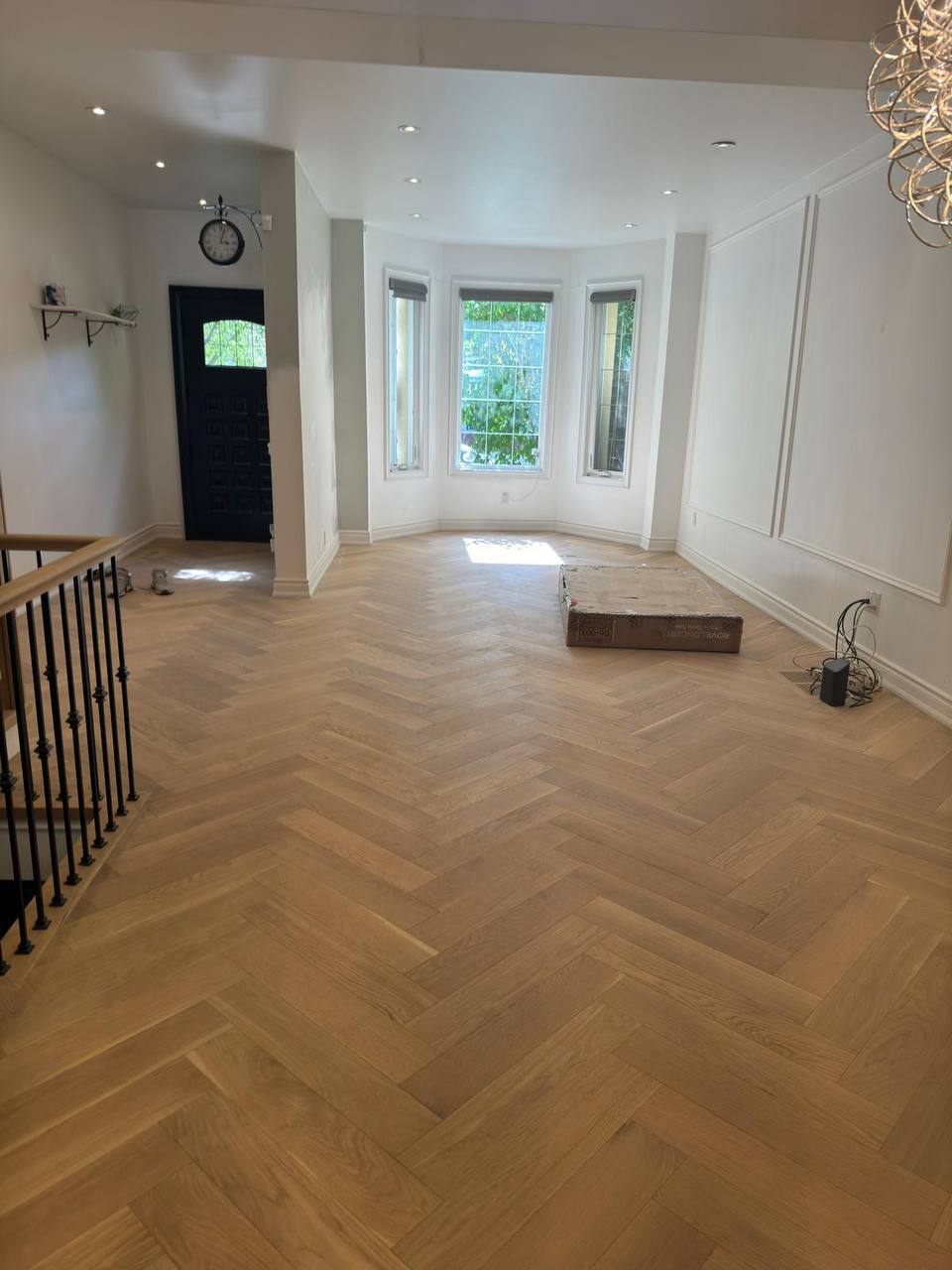 Open living room herringbone hardwood flooring